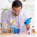 Young male chemist in perfume synthesis concept