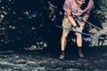 Young Male Climber Hanging On A Rock On A Rope And Looks Somewhere On The Wall. Extreme Lifestyle Outdoor Activity Concept Royalty Free Stock Photo