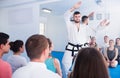 Karate coach teaching adults