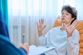 Young male college student in therapy session with psychologist Royalty Free Stock Photo