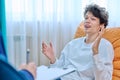 Young male college student in therapy session with psychologist Royalty Free Stock Photo