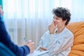 Young male college student in therapy session with psychologist Royalty Free Stock Photo