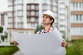 Young architect in front of apartment building