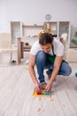 Young male contractor cleaning the flat after kids` party