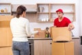 Young male contractor and female customer in moving concept Royalty Free Stock Photo