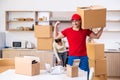 Young male contractor and female customer in moving concept Royalty Free Stock Photo