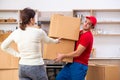 Young male contractor and female customer in moving concept Royalty Free Stock Photo