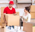 Young male contractor and female customer in moving concept Royalty Free Stock Photo