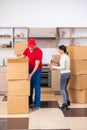 Young male contractor and female customer in moving concept Royalty Free Stock Photo