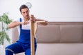 Young male contractor installing furniture at home