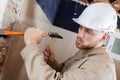 young male contractor using hammer and chisel Royalty Free Stock Photo