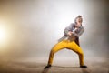 Young male with crossed arms and legs apart is waiting for his solo in dance Royalty Free Stock Photo