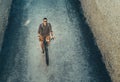 Young Male Cyclist Riding On Bike Down The Street, Top View. Daily Lifestyle Urban Resting Concept