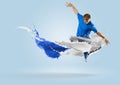 Young male dancer jumping with splash of paint Royalty Free Stock Photo