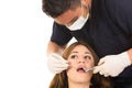 Young male dentist examinig beautiful girl's teeth Royalty Free Stock Photo