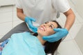 A young male dentist and happy female patient. Dentist office lifestyle scene. Doctor practice. Patient health care Royalty Free Stock Photo