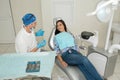 A young male dentist and happy female patient. Dentist office lifestyle scene. Doctor practice. Patient health care Royalty Free Stock Photo