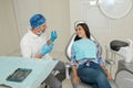 A young male dentist and happy female patient. Dentist office lifestyle scene. Doctor practice. Patient health care Royalty Free Stock Photo