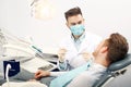 A young male dentist and a patient Royalty Free Stock Photo