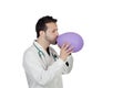 Young Male Doctor Blowing Balloon