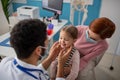 Young male doctor checking little girl's lymph nodes in his office. Royalty Free Stock Photo