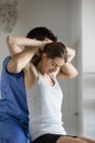 Young male doctor chiropractor or osteopath fixing woman`s back in health office Royalty Free Stock Photo