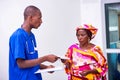 Young male doctor giving prescription to patient woman Royalty Free Stock Photo