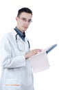 Young male doctor in glasses, standing with a ballpoint pen in hand and ECG. Looking at the camera Royalty Free Stock Photo