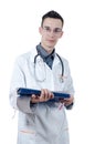 Young male doctor in glasses, standing with a ballpoint pen in hand and ECG. Looking at the camera. Royalty Free Stock Photo