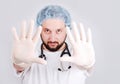 Young male doctor with hands in front and surgery Royalty Free Stock Photo