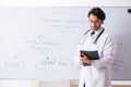 The young male doctor neurologist in front of whiteboard