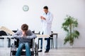 Young male doctor pediatrist and boy in wheel-chair