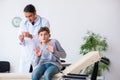 Young male doctor pediatrist and boy in wheel-chair