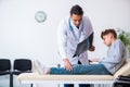 Young male doctor pediatrist and boy in wheel-chair