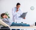 Young male doctor pediatrist and boy in wheel-chair