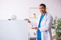 Young male doctor in presentation concept Royalty Free Stock Photo