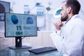 Young male doctor specialised in brain tumor checking a bran in hospital laboratory Royalty Free Stock Photo