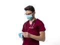 Young male doctor with stethoscope over neck with syringe, isolated on white Royalty Free Stock Photo