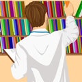 Young male doctor or student taking book from shelf in office or library