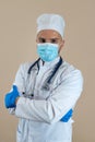 Young male doctor wearing white coat gloves and face protective medical mask stethoscope isolated Royalty Free Stock Photo