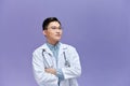 young male doctor in white coat with stethoscope posing with crossed arms Royalty Free Stock Photo