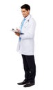 Young Male Doctor Writing On Clipboard Royalty Free Stock Photo