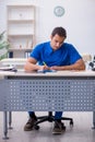 Young male doctor writing prescription in the clinic Royalty Free Stock Photo