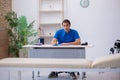 Young male doctor writing prescription in the clinic Royalty Free Stock Photo