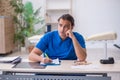 Young male doctor writing prescription in the clinic Royalty Free Stock Photo