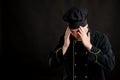 Young male dressed in a black chef suit has headache Royalty Free Stock Photo