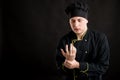 Young male dressed in a black chef suit has wrist pain Royalty Free Stock Photo