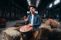 Young male drummer against african wooden drum