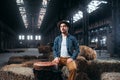 Young male drummer against african wooden drum Royalty Free Stock Photo