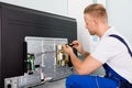 Electrician Checking Television Royalty Free Stock Photo